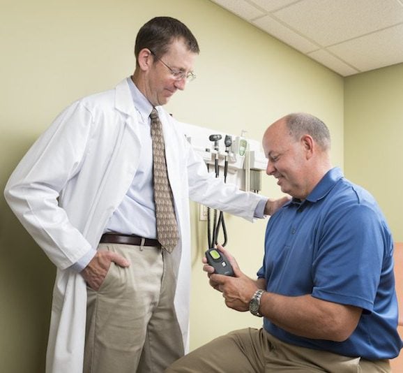 Physician and a patient holding an Inspire Sleep Remote
